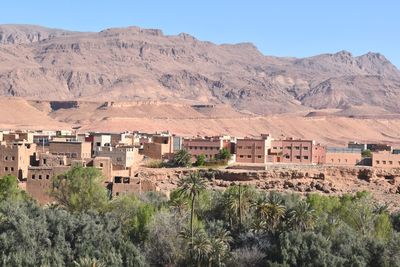 Scenic view of landscape and mountains against clear sky