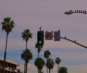 Low angle view of road sign against sky