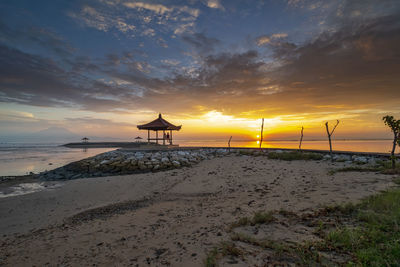 Scenic view of beach against sky during sunset