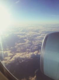 Cropped image of airplane flying over cloudscape