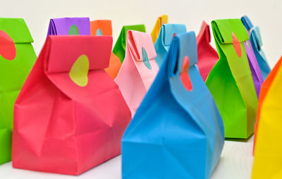 Colorful shopping blank folded paper mockup bags for branding logotype identity design.