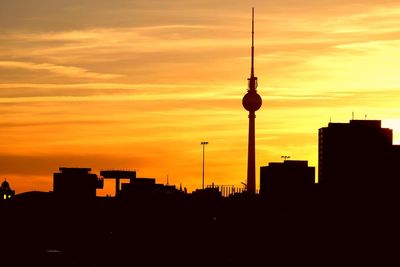 Silhouette of buildings against sky during sunset