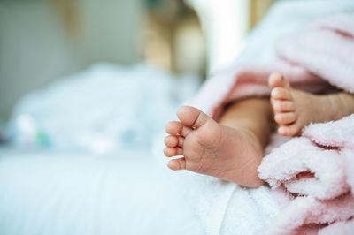 Low section of baby feet in blanket