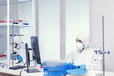 Rear view of woman working in laboratory