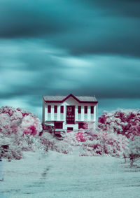 House by building against sky during winter