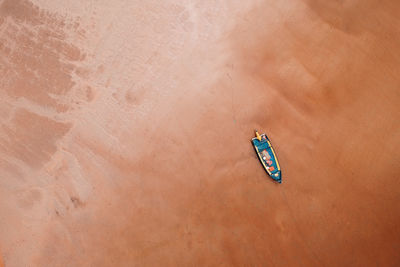 Directly above shot of rowboat on sand at beach