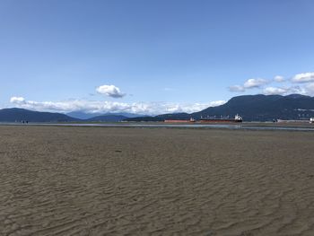 Scenic view of beach against blue sky