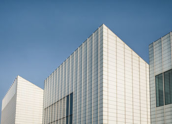 Low angle view of modern building against clear blue sky