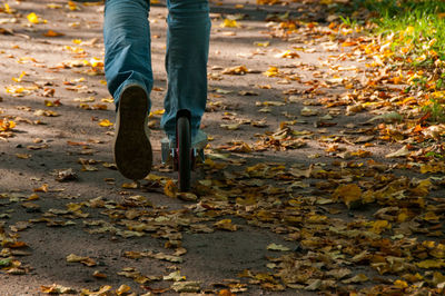 Low section of man on push scooter at park