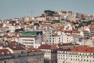 Buildings in city against clear sky