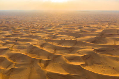 Scenic view of desert against sky during sunset