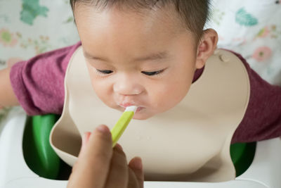 Close-up portrait of cute boy eating