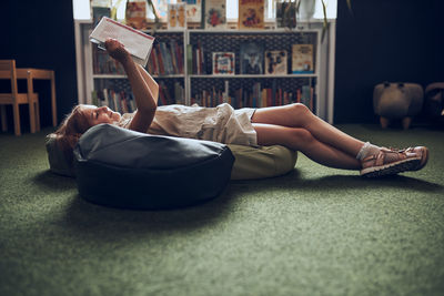 Portrait of woman sitting on sofa at home