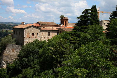 High angle view of trees by buildings in town