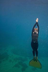 Woman scuba diving in sea