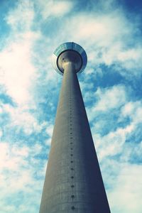 Low angle view of tower against cloudy sky
