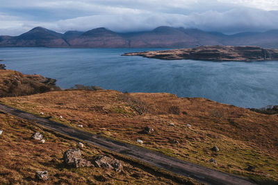 Scenic view of sea and mountains against sky