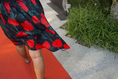 Low section of woman standing on tiled floor