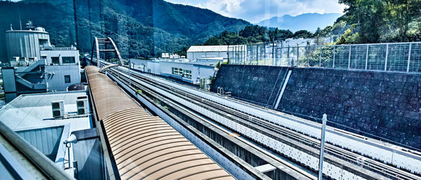 High angle view of railroad tracks amidst mountains against sky