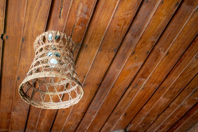 Low angle view of light bulbs hanging from ceiling