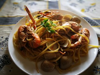 Close-up of pasta served in plate on tablecloth