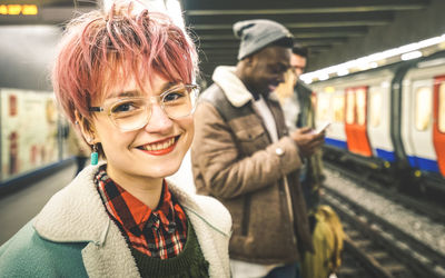 Portrait of smiling woman at railroad station