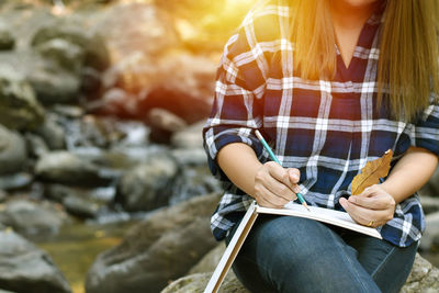 Woman sitting on rock