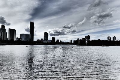 Scenic view of sea by buildings against sky