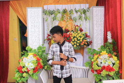 Boy wearing necktie while standing on decorated stage