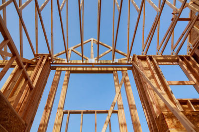 Low angle view of metallic structure against blue sky