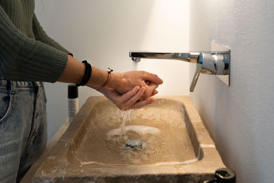 Cropped image of man working in sink