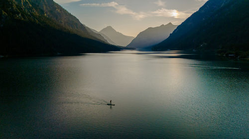 Scenic view of lake and mountains against sky