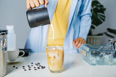 Midsection of woman holding coffee