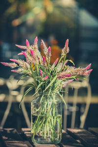 Glass vases and flowers of various colors in a vintage style. part of the home decor.