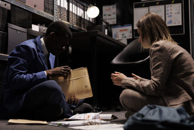 Rear view of woman using laptop at table