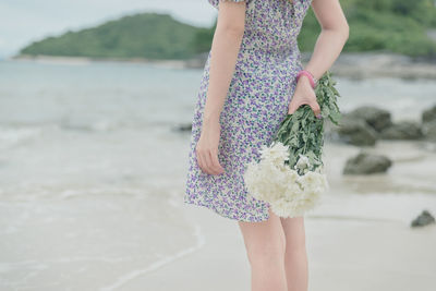 Rear view of woman standing on beach