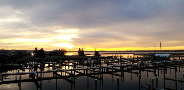 View of harbor against cloudy sky
