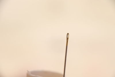 Close-up of cross on wood against white background