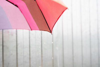 Rain drops on a colorful umbrella. close up of colorful umbrella part with raindrops