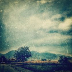 Scenic view of landscape against cloudy sky