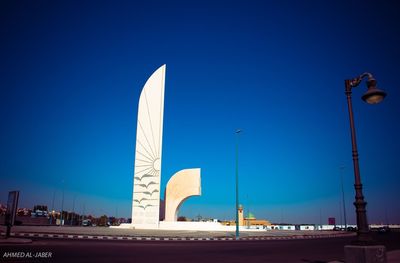 Low angle view of illuminated building against blue sky