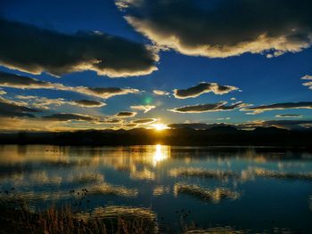 Scenic view of lake against sky during sunset