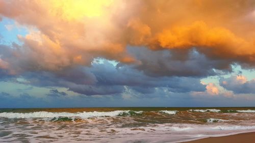 Scenic view of sea against cloudy sky