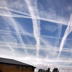 Low angle view of vapor trails in sky