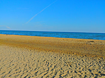 Scenic view of sea against clear blue sky