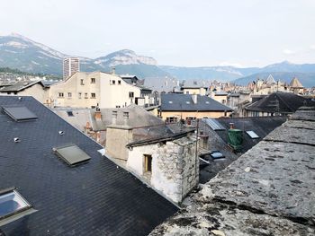 Buildings in town against sky