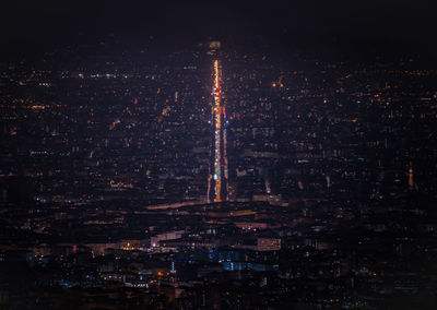 Aerial view of city lit up at night