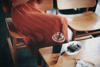 High angle view of man holding tea cup on table