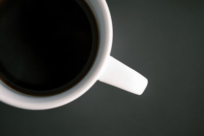 High angle view of coffee cup against black background