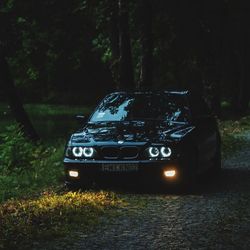 View of abandoned car on field